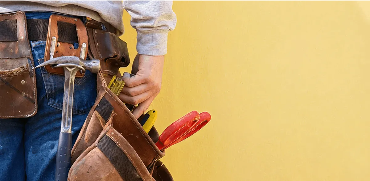 Handyman with tool belt ready for home repairs and maintenance in Worcester, MA